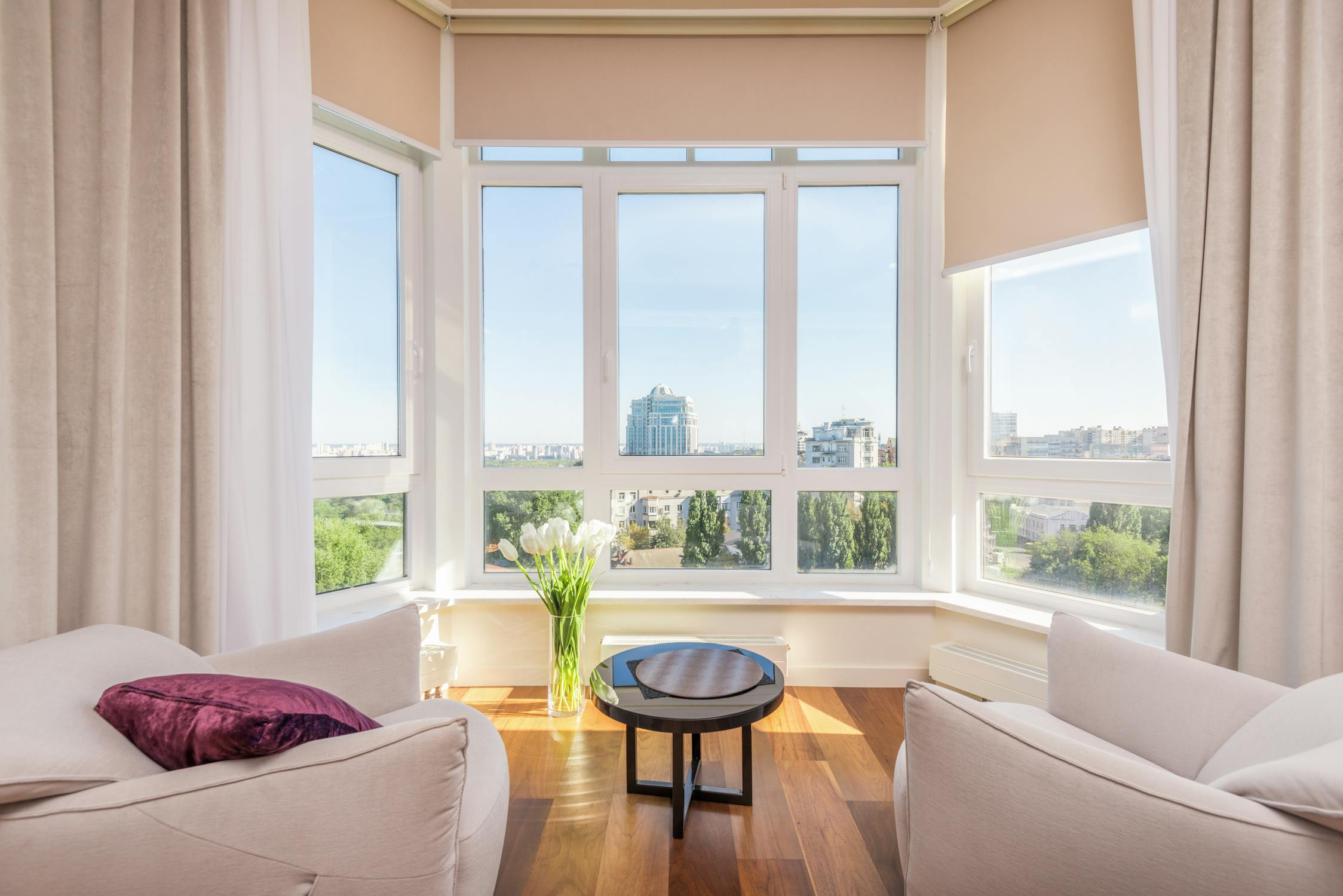 Modern interior with bay windows and city views