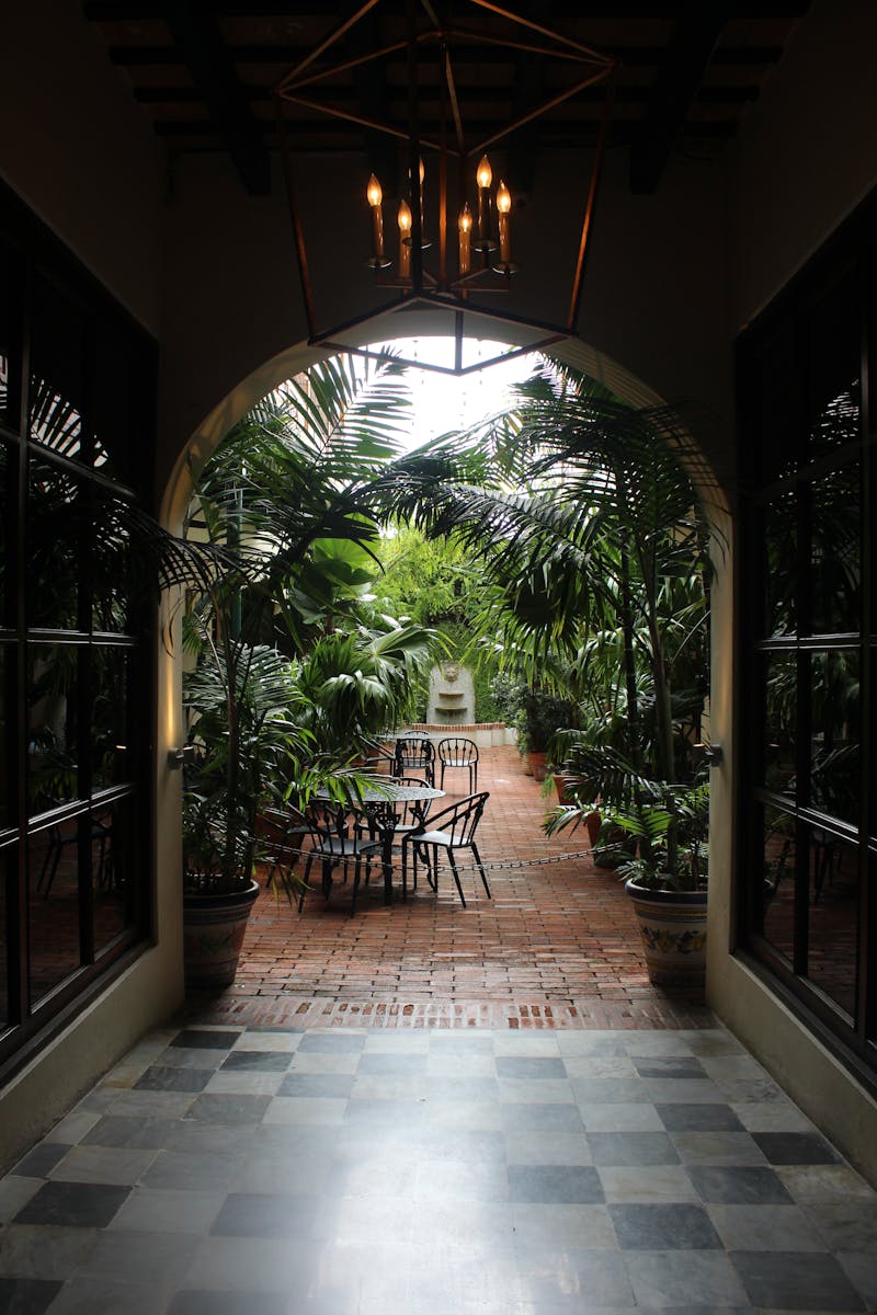 Elegant interior archway leading to tropical garden courtyard